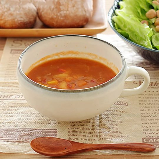Minoyaki single handle white ceramic bowl cup with hearty soup and bread.